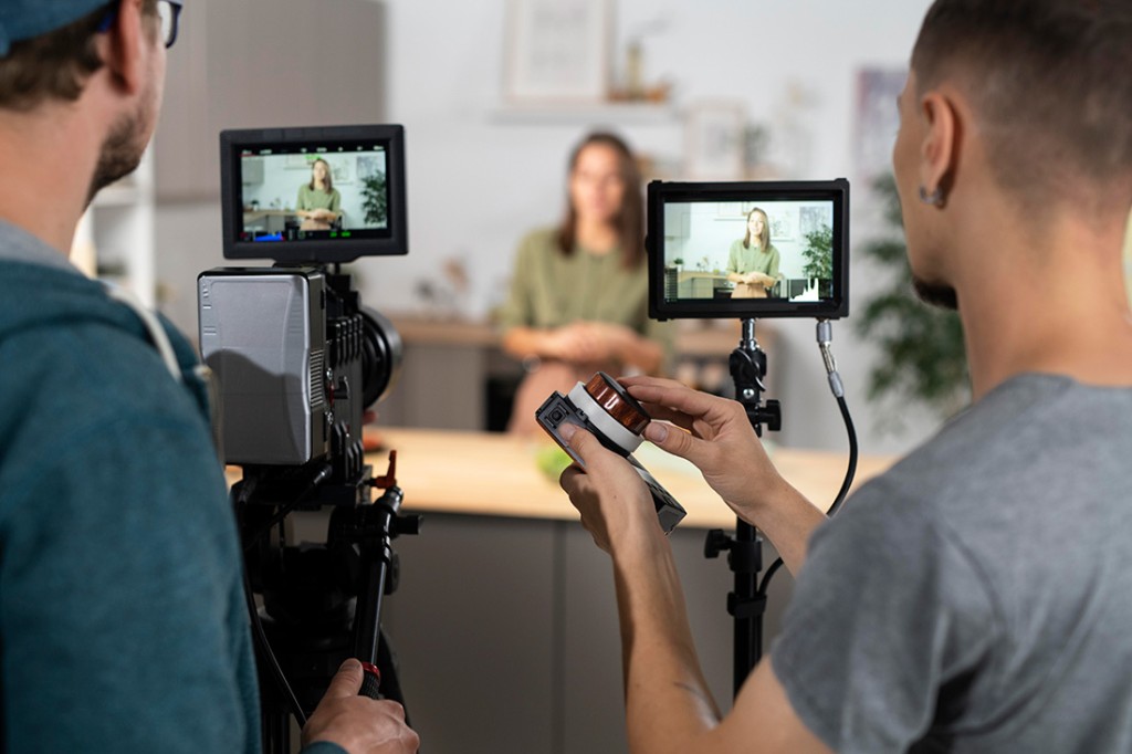Two people recording a interview of a women