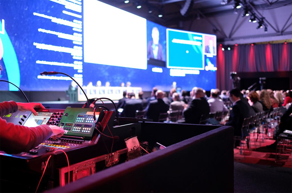 A man operating digital display on a corporate event